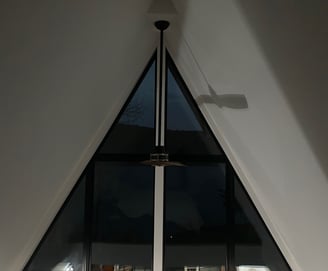 custom A-frame window wall with trim free drywall