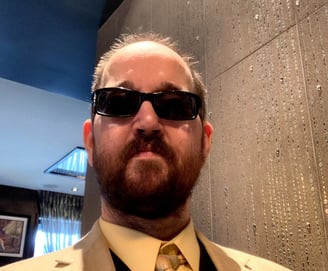a man in a suit and sunglasses