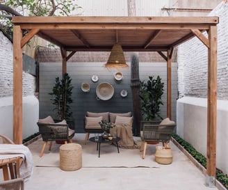 Outdoor terrace with seating and green plants, offering a serene atmosphere in Barcelona apartment