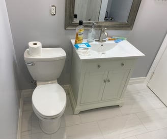 a bathroom with a toilet and a toilet paper roll