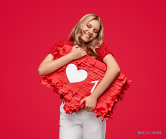 a woman holding a pinatable shaped pinatable