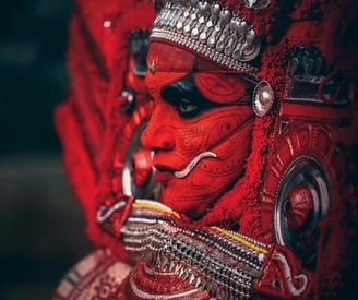 A side view of artist playing traditional Theyyam dance form