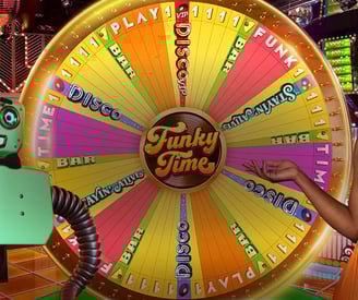 a woman in a pink dress standing next to a wheel of fortune
