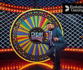 a man in a suit and tie standing in front of a wheel of fortune