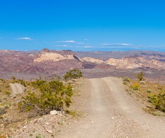 dirt road with mountains in the background