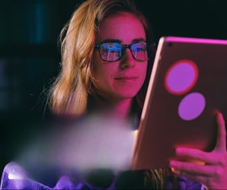 a woman in glasses and glasses is looking at a laptop