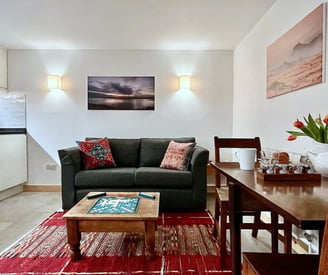 a lounge area with kitchen and dining space