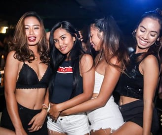 a group of women in black bras and white shorts