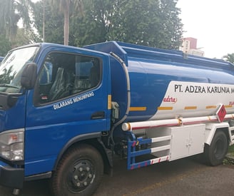 a blue truck with a white tank on it