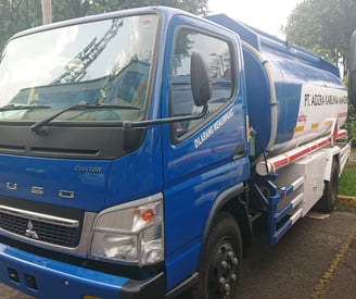 a blue truck with a white truck behind it
