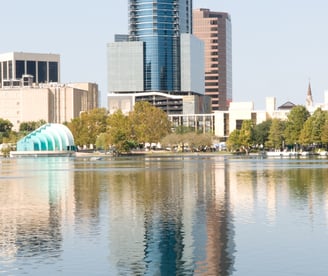 a city skyline with a fountain in the foreground