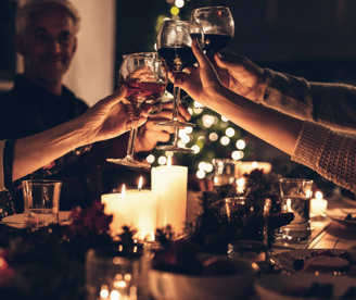 a group of people toasting with wine glasses