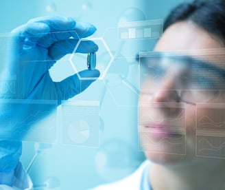 a woman in a lab coat and gloves holding a piece of equipment