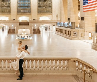 a bride and groom standing on a staircase way on the Grand Central Station