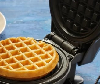 a waffler on a plate with two waffles on it