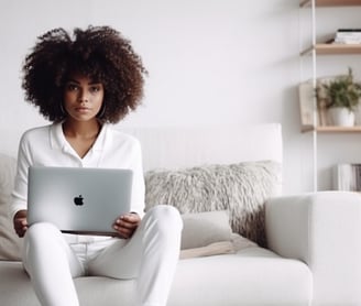 a woman sitting on a couch with a laptop