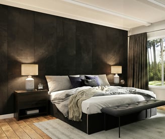 minimalist bedroom with a black color palette and large windows that look out into green trees