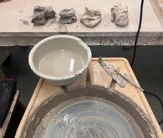 Piles of clay and a potters wheel