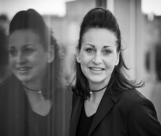 a woman in a black jacket and glasses