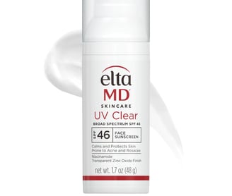 a white bottle of liquid with a white background
