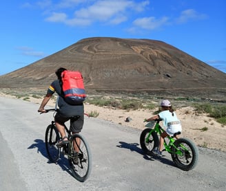 a man anb a child riding a bike 