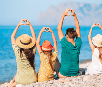 a group of people sitting on the beach
