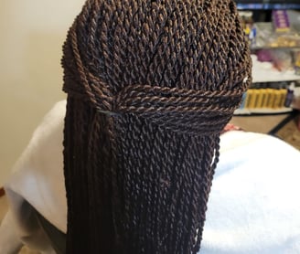 a woman with a large braid braid hair style