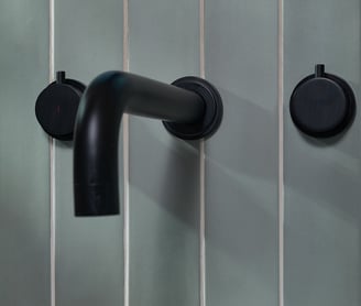 blue vertical tile with white grout and black bath tap 
