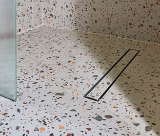large-format terrazzo tiles in a wet room with tile in shower base