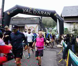 a man running in a race with a woman in pink