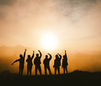 a group of people standing on a hill top