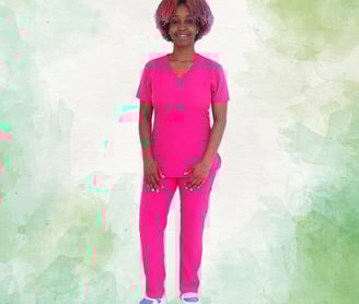 a woman in a pink scrub suit standing in front of a green background