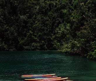 a boat is docked at a dock with a boat in the water
