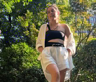 Cynthia Scellos, timeless styless fashion for women in a black top and white shorts