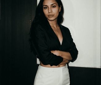a woman in a black shirt and white skirt