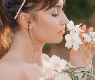 a woman with a smelling flowers