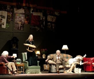 a group of older people performing on a stage