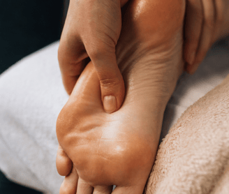 a person is getting a foot massage