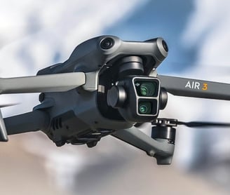 DJI Air 3: a small drone flying over a mountain