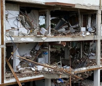 a building with a bunch of rubble and debris on the ground