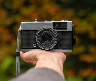 a person holding a camera on his hand