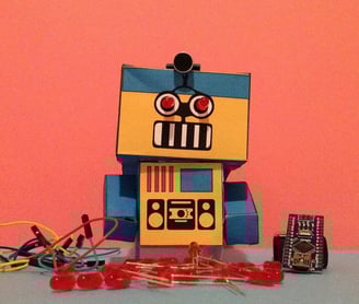 a robot toy with a box of buttons and a toy