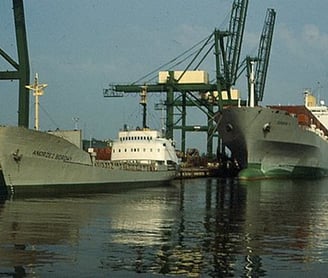 a large ship is docked at a dock