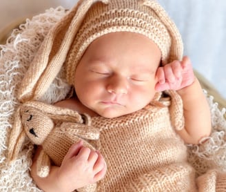 a baby laying in basket