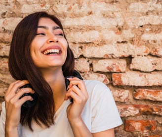 a girl standing and smiling.