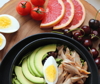 a bowl of fresh vegetables and fruits on table