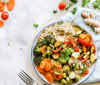 a vegetable bowl on table with fork