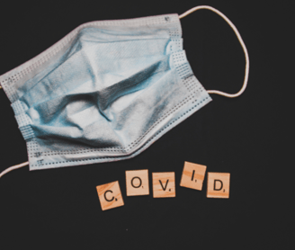 a mask and written covid with cross word