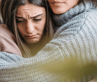 two womens hugging