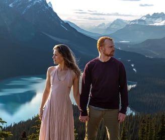 Couple holding hands looking at peyto lake